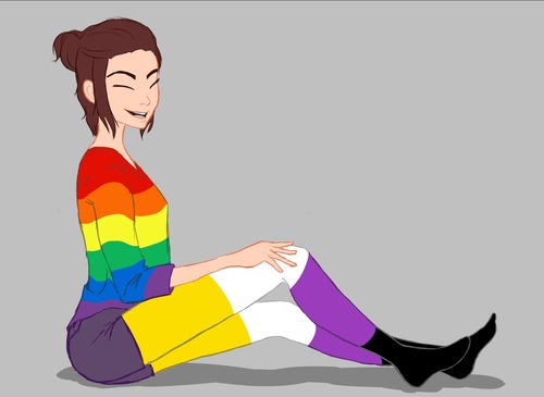Person sitting on the floor smiling ith pride colour clothes.